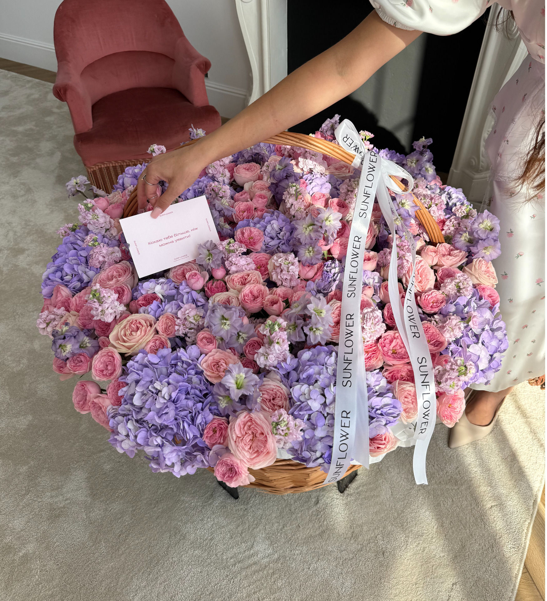 Arrangement in a basket of lavender hydrangeas, shrub roses and delicate mattiola