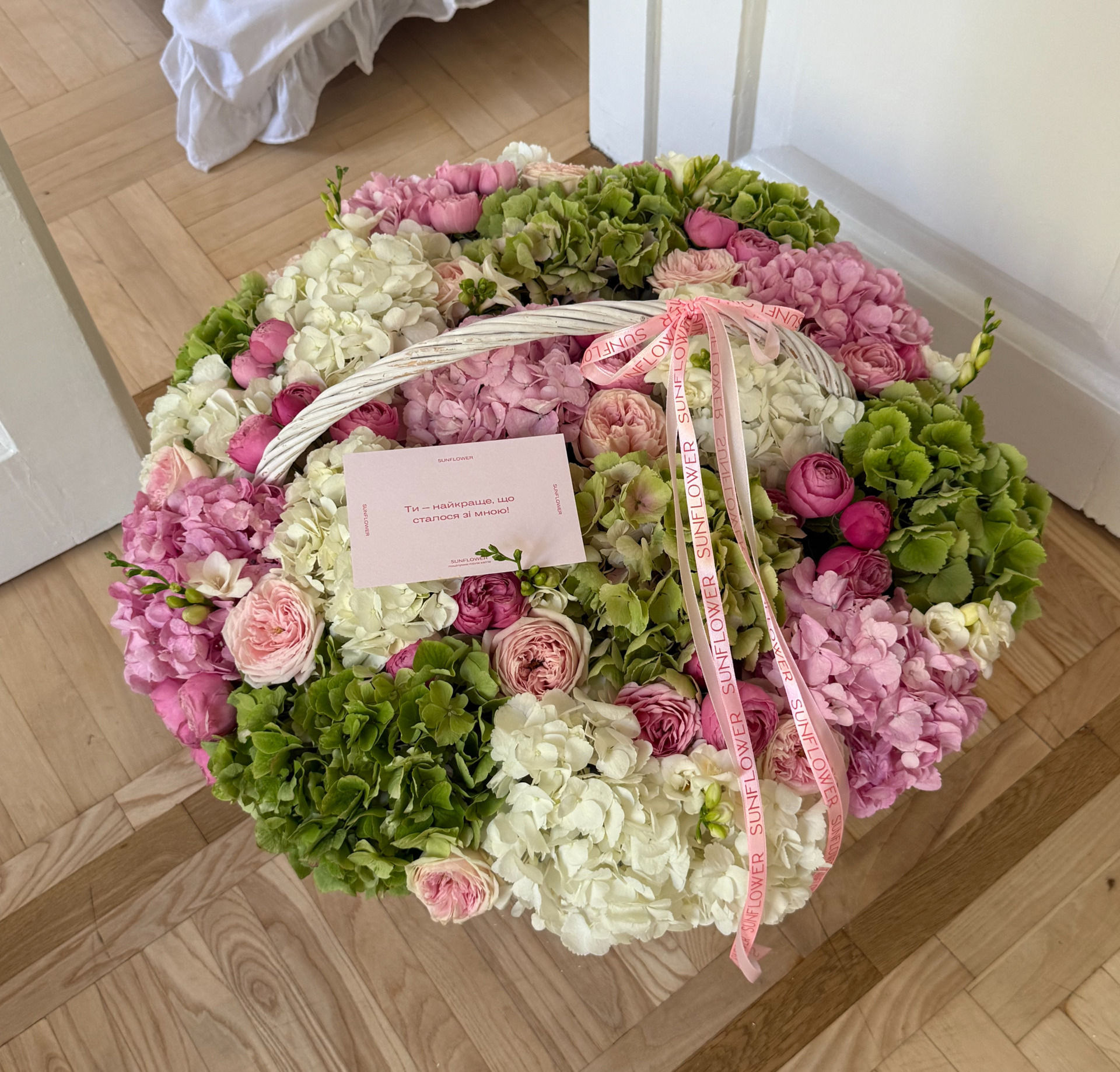 Arrangement in a basket with green hydrangeas