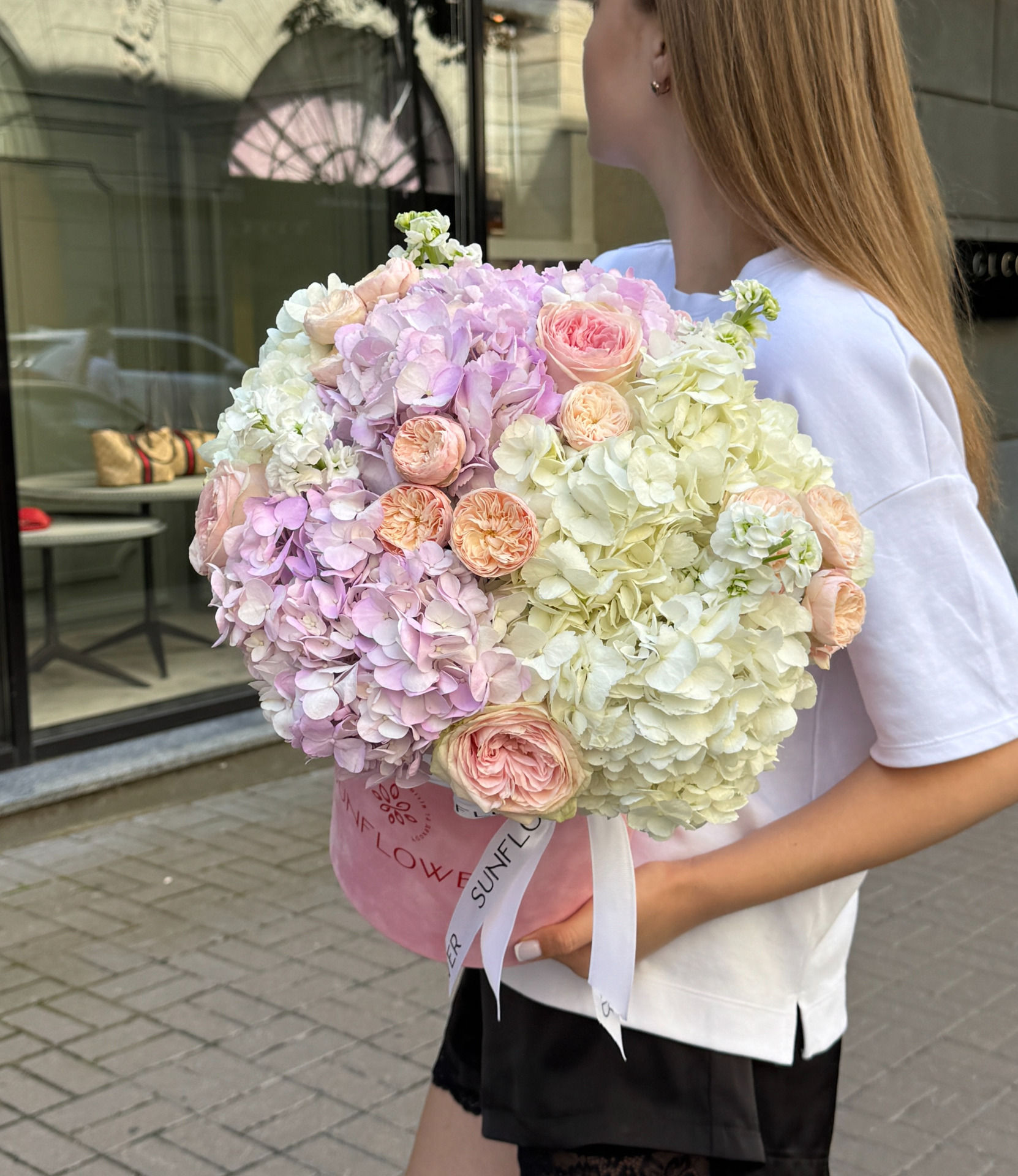 A collection box of lavender and white hydrangeas, shrub roses and mattiola