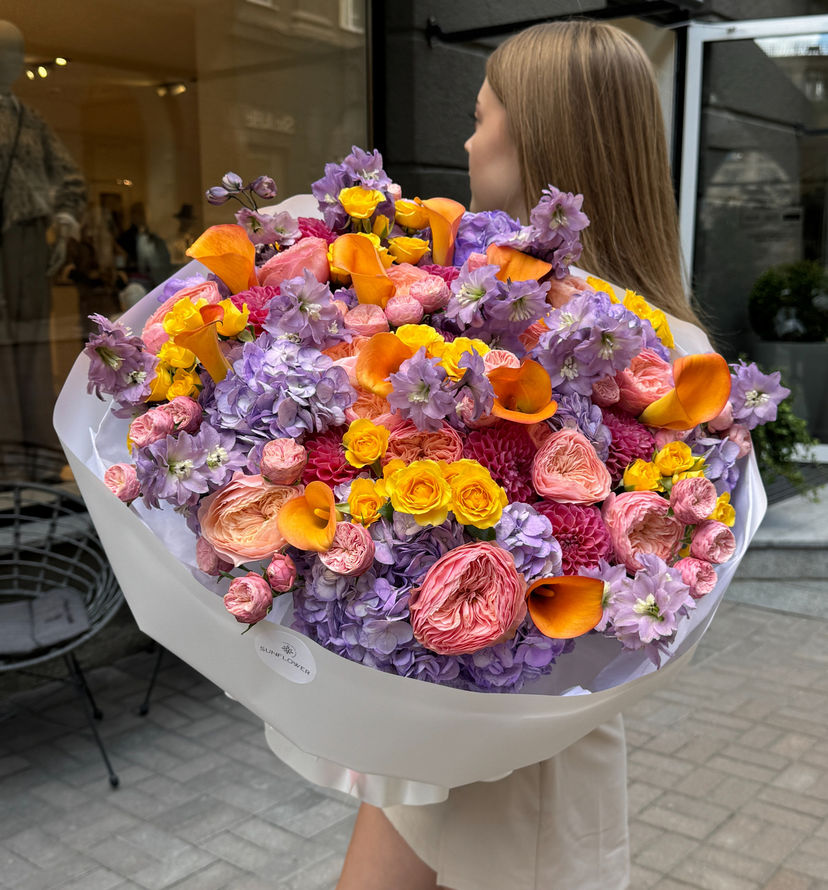 A vibrant mix of roses, hydrangeas, and delphiniums.
