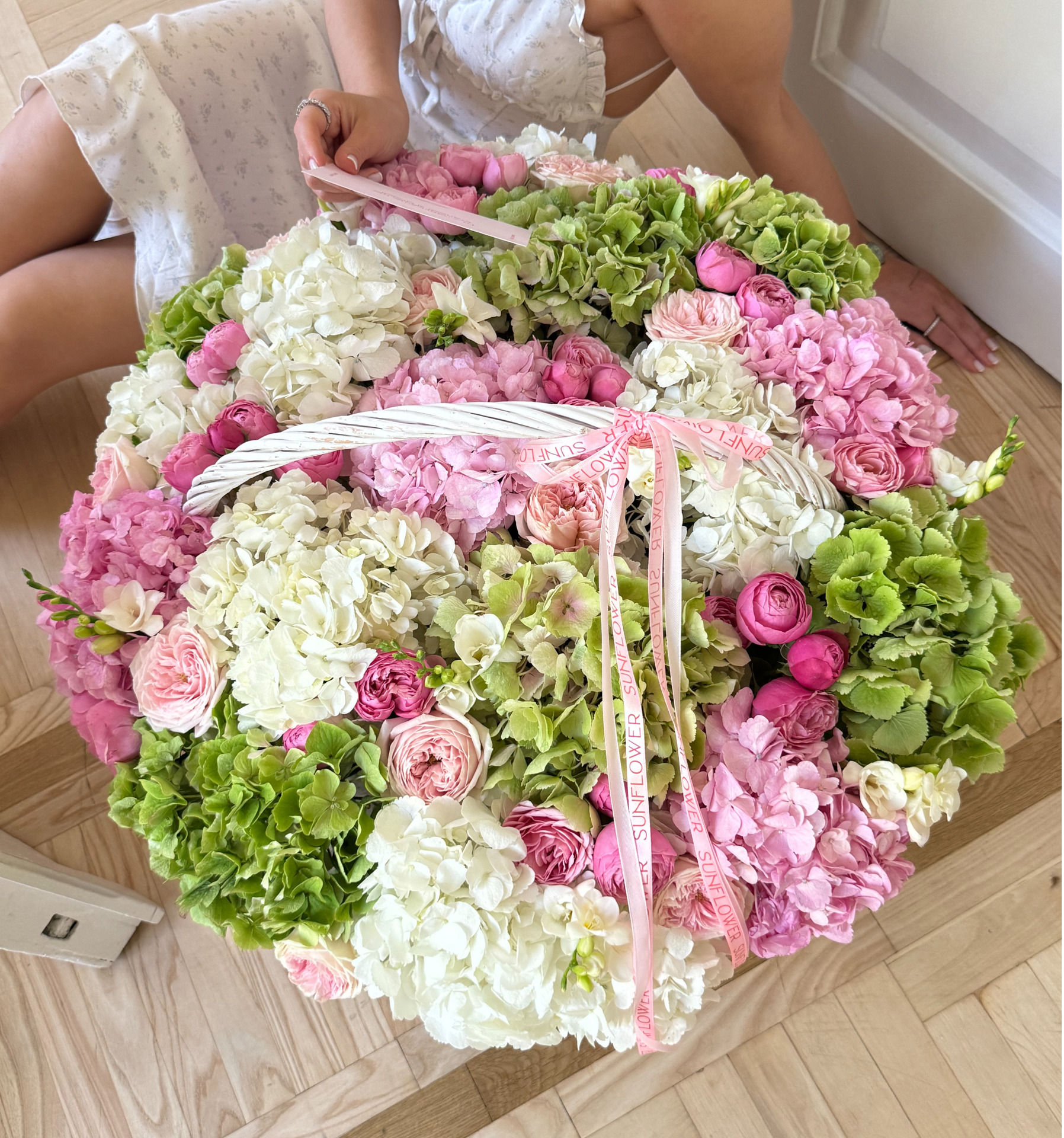 Arrangement in a basket with green hydrangeas