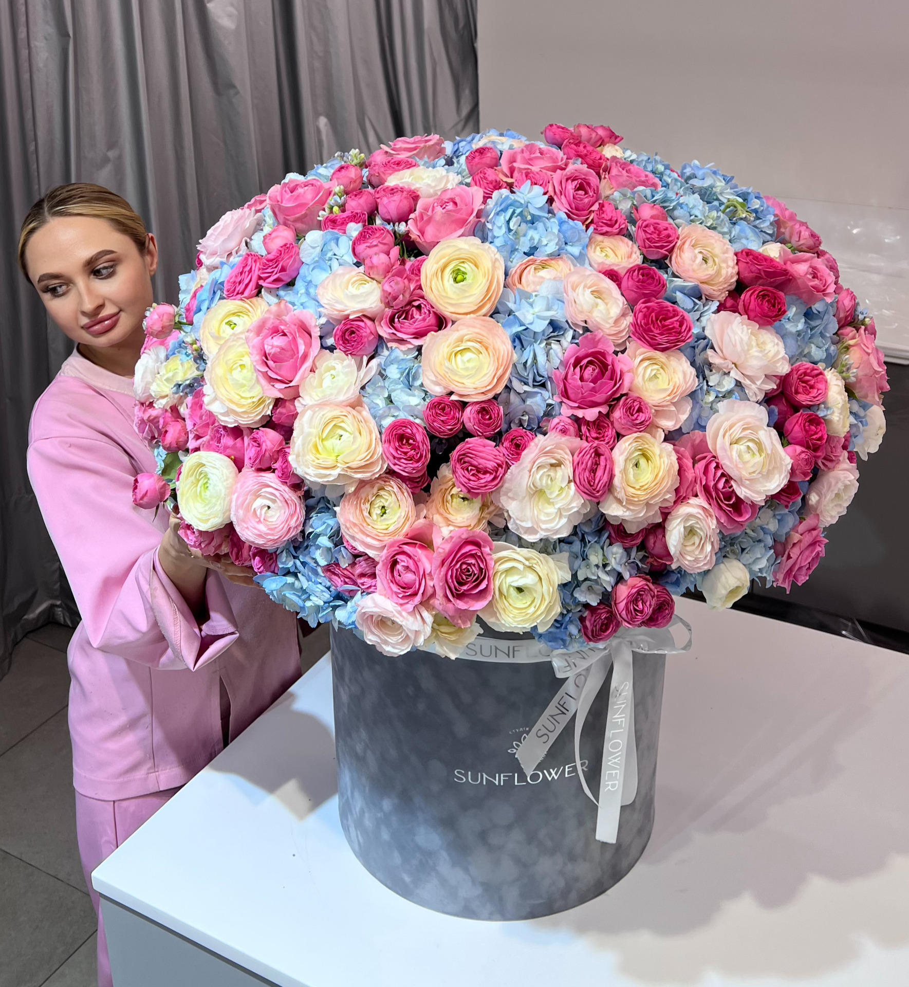 Box M of bush roses and blue hydrangeas