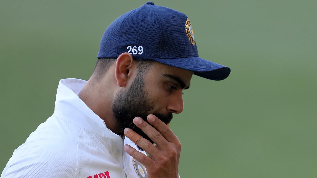Virat Kohli holding Test cap