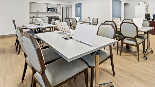activity and art room with tables and materials for painting, cooking, and other crafts