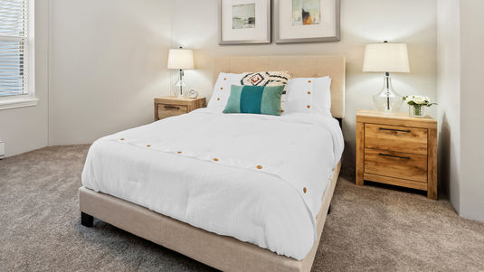senior apartment model bedroom with queen sized bed