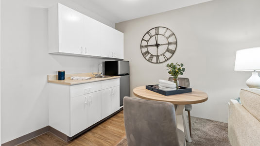 senior apartment model kitchen with cabinets mini fridge and sink