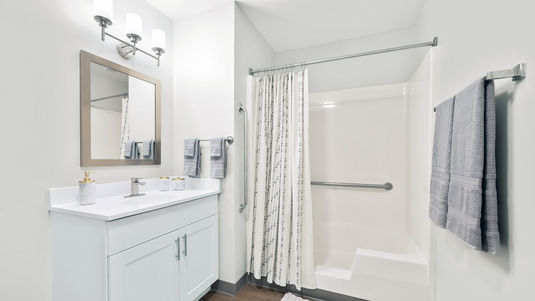 Apartment bathroom with white and light gray adornments