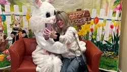 Residents enjoy taking pictures with the Easter Bunny that visited the community
