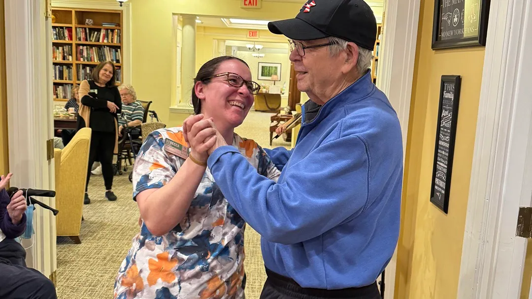 Resident dances with staff while listening to some good music