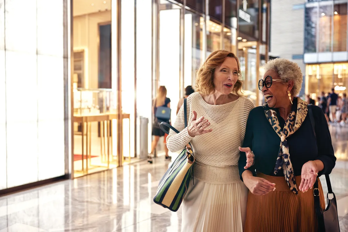 Two women chat while shopping