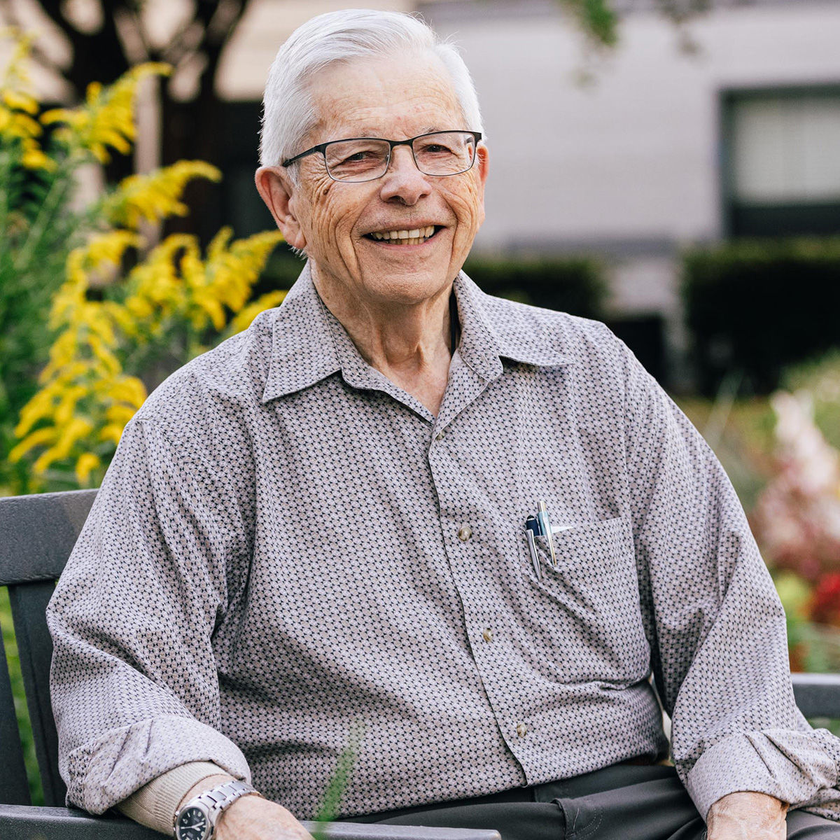 Holiday resident, Howard, photographed smiling and enjoying the afternoon on a bench outside