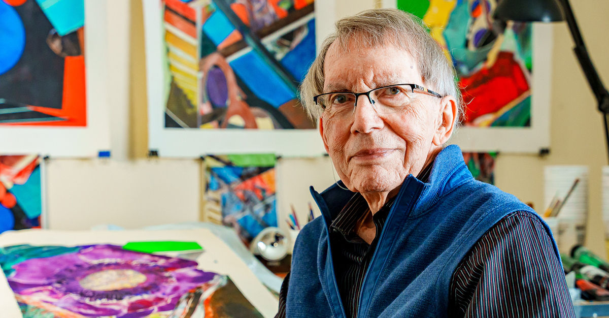 Atria Stamford resident William posing with his artwork