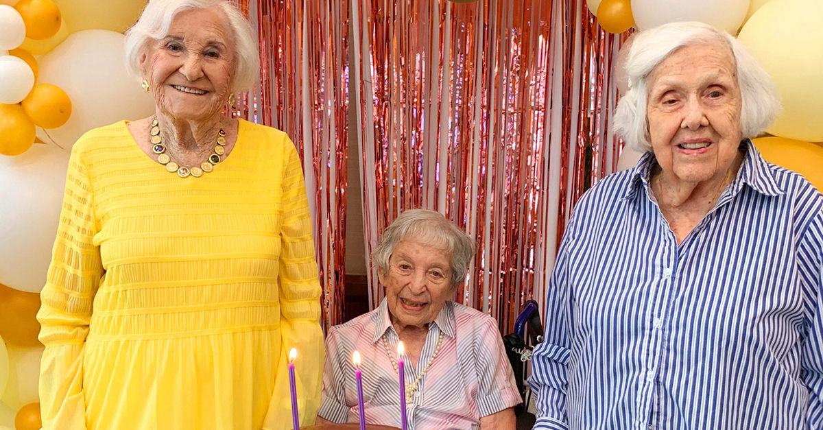 Three Atria Senior Living residents celebrating their 100th birthdays together