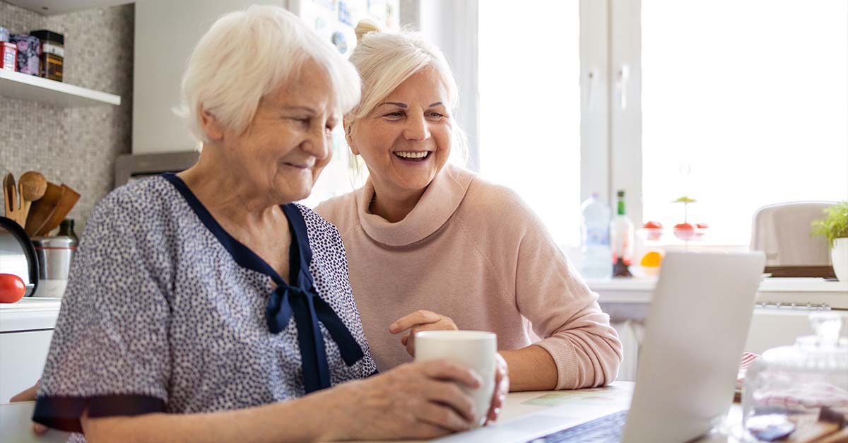 Older woman and daughter on laptop together