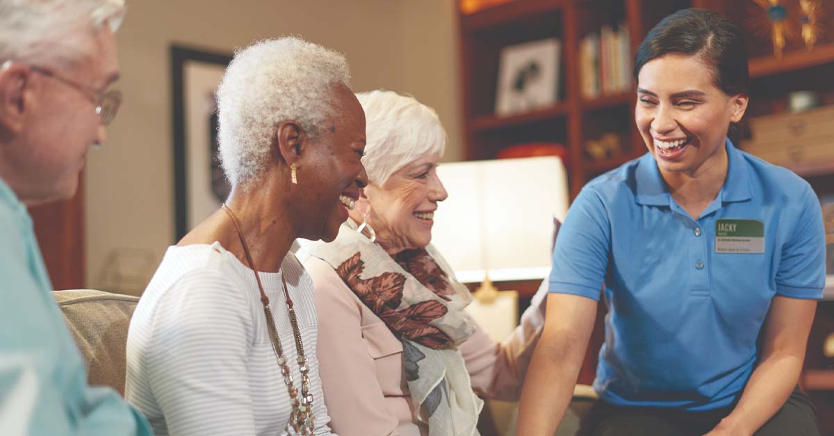 Three Atria residents and an Atria employee sitting together