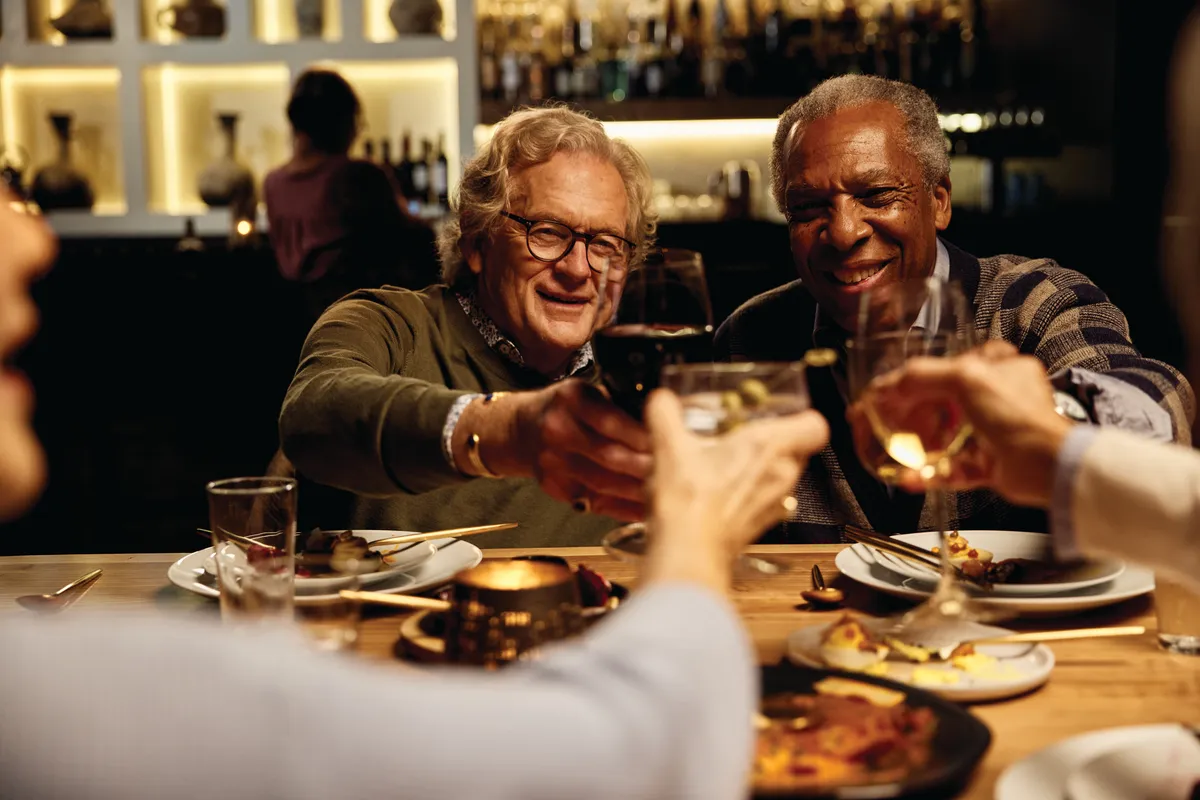 A group of friends raise a toast over dinner