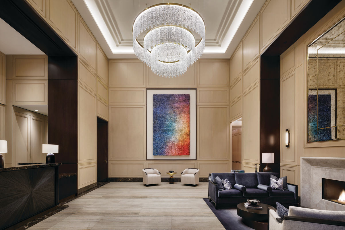 Coterie Hudson Yards lobby with crystal chandelier, larger artwork, fireplace and seating