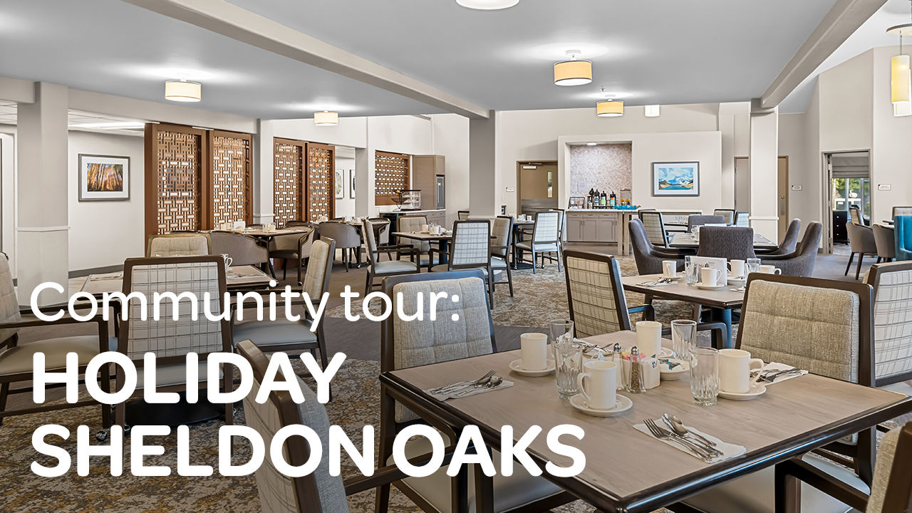 Dining area with neatly set tables, cushioned chairs, and warm lighting. Text reads: "Community tour: Holiday Sheldon Oaks."
