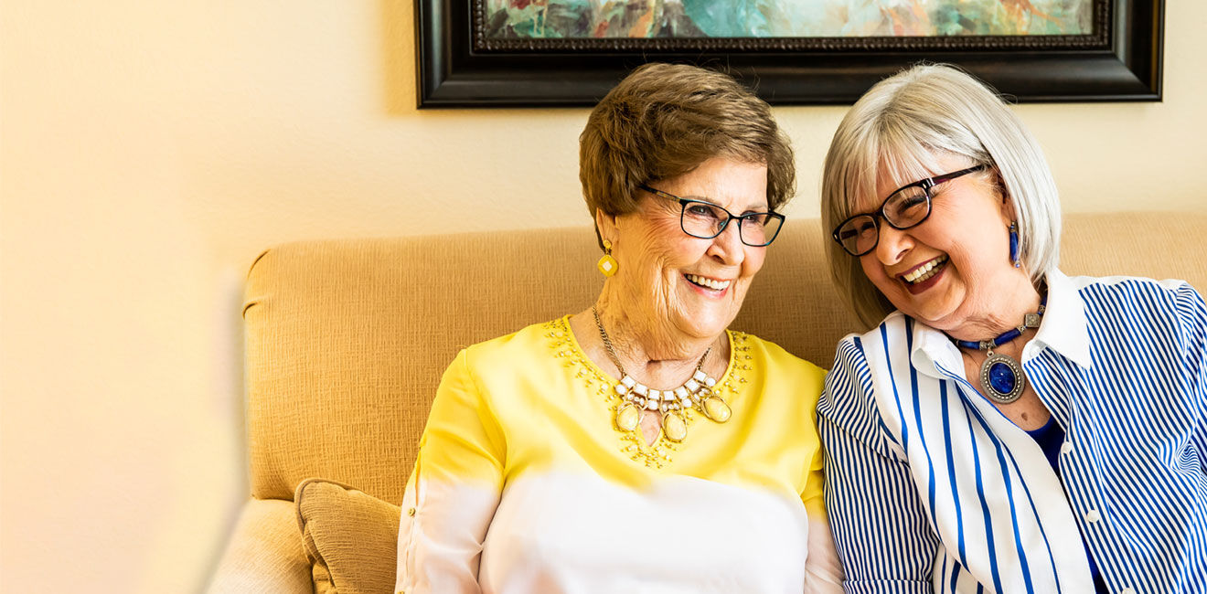 Two ladies sitting on the couch together