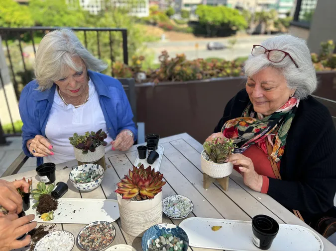 two senior women gardening together