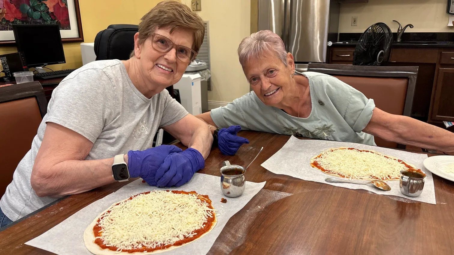 Residents hand craft their own pizza and enjoy eating their creations