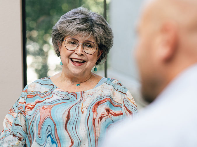 senior woman smiling at a friend