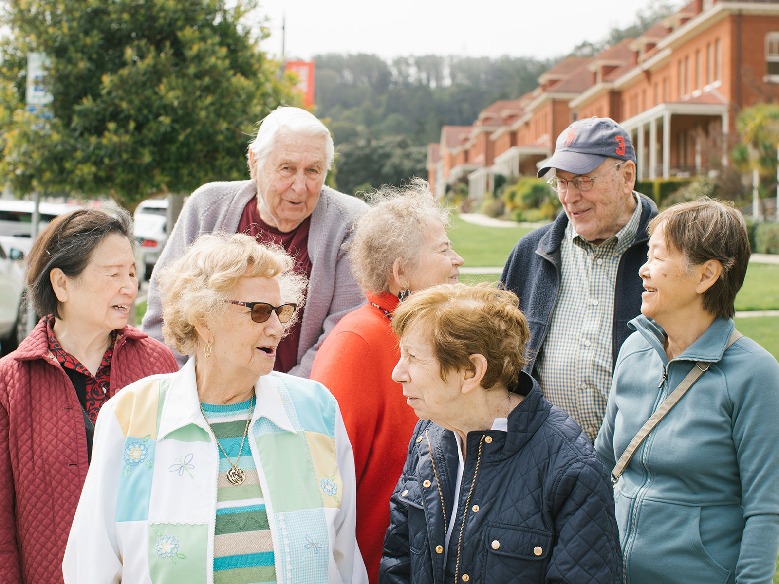 Older adults going on an outing. They are in jackets for the cold fall day.