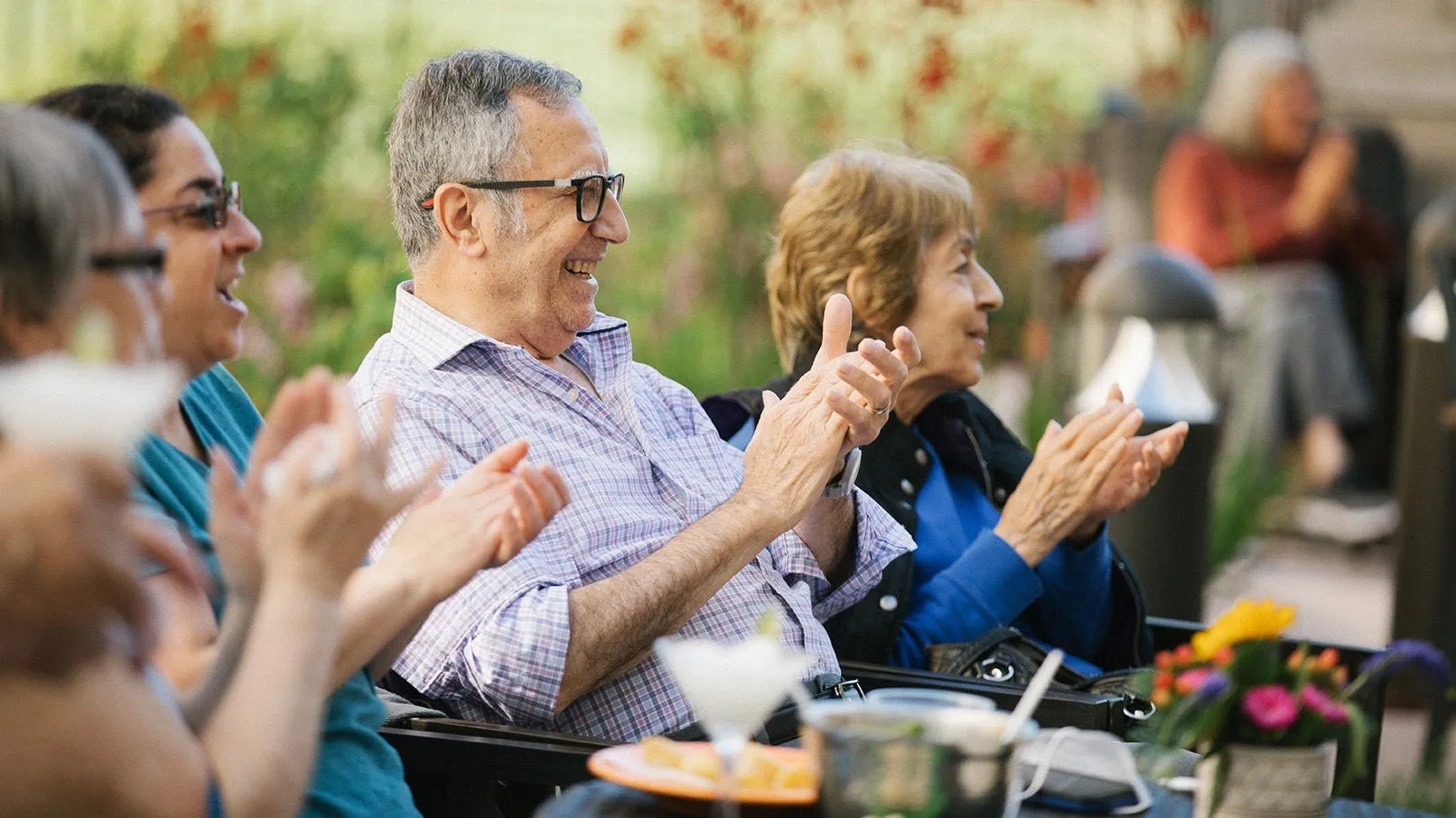 Senior Living residents enjoying time together outside on the patio