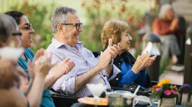 Senior Living residents enjoying time together outside on the patio