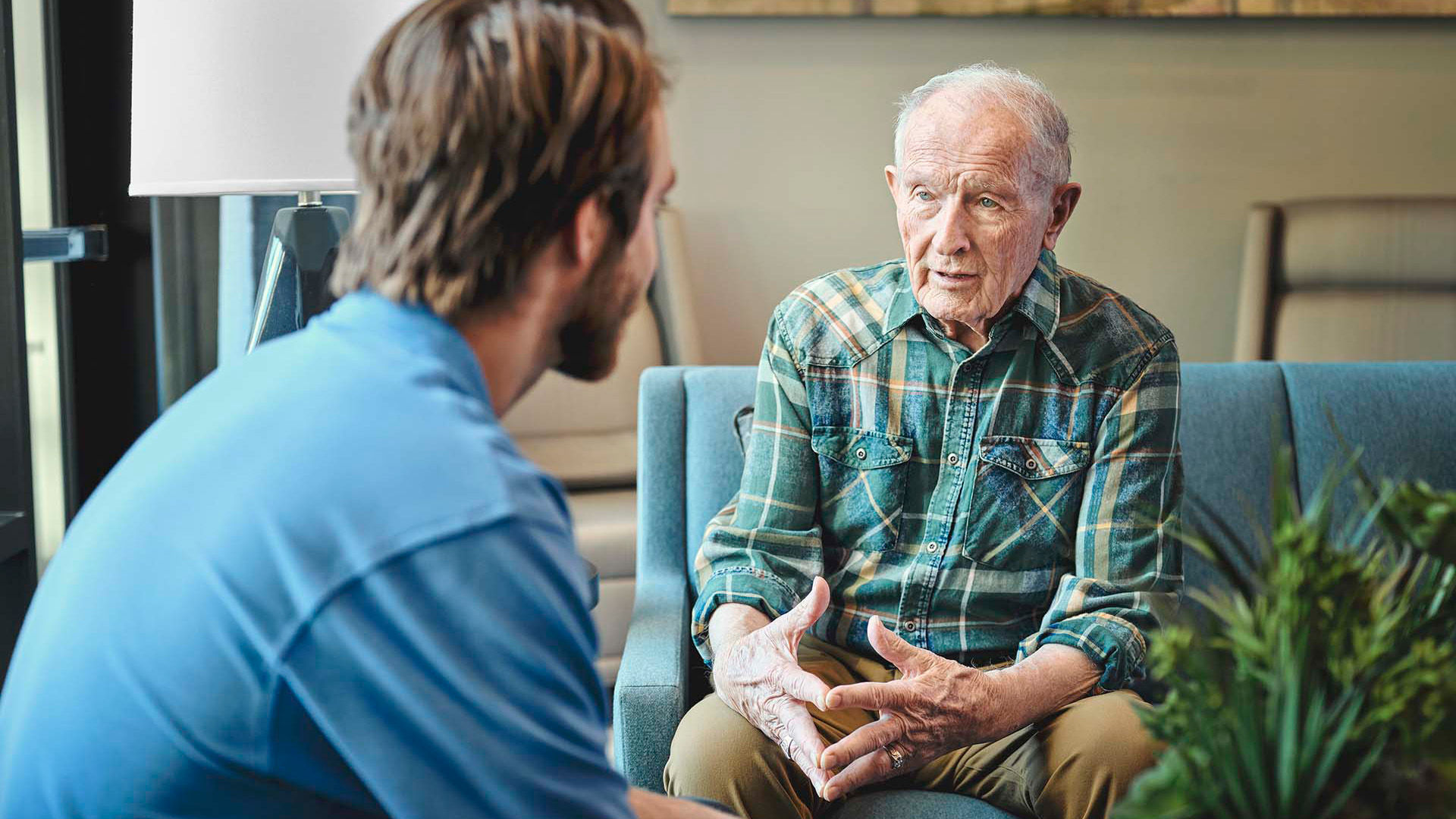 Older man talking with a Atria Senior Living employee
