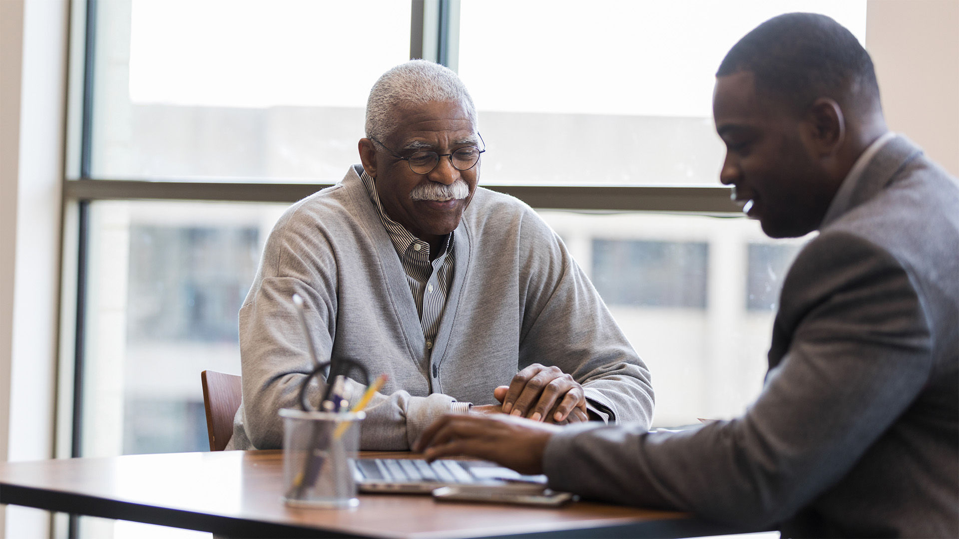 Senior man discussing senior living costs with financial advisor