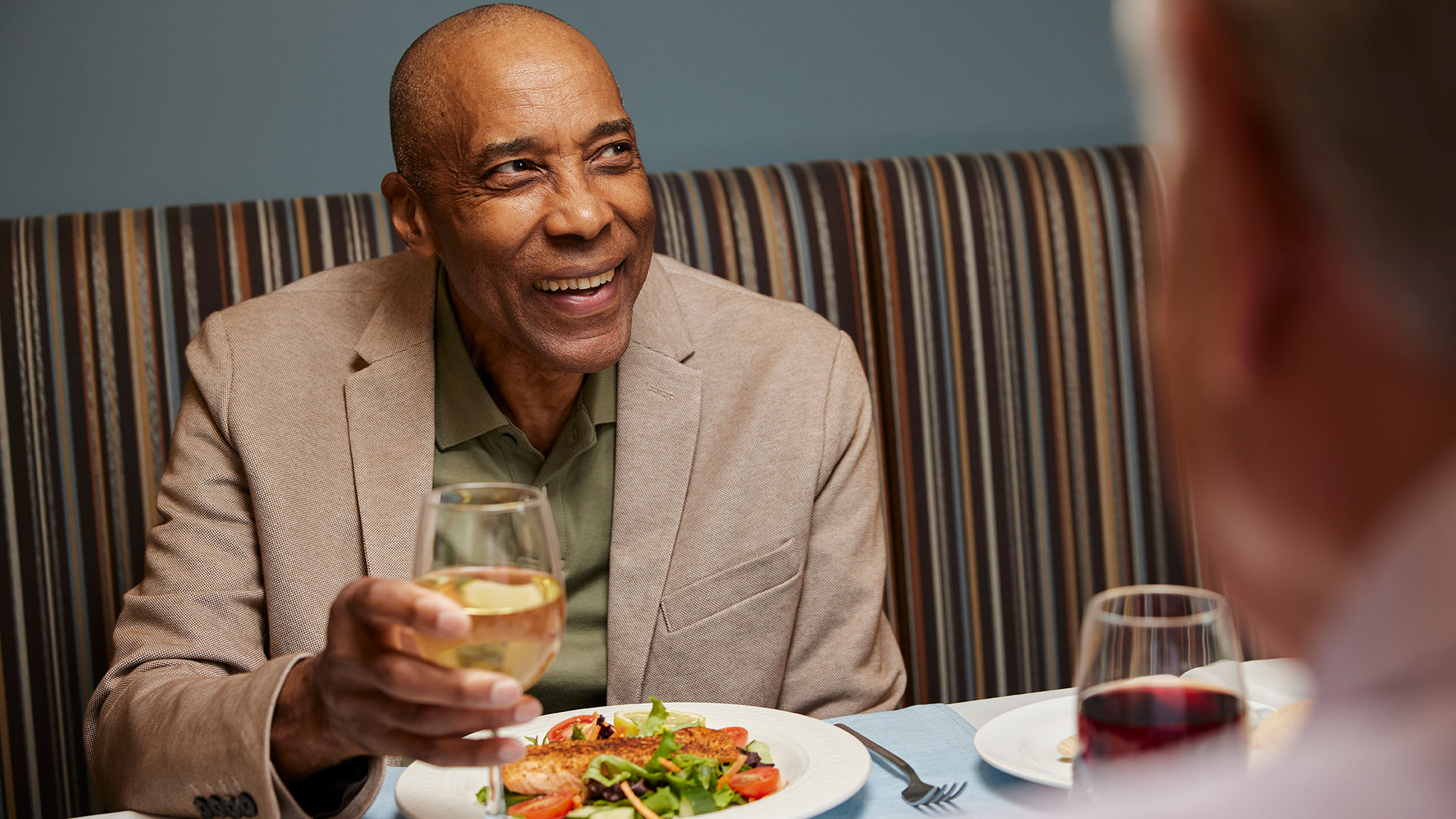 Senior man enjoying dinner at a senior living community