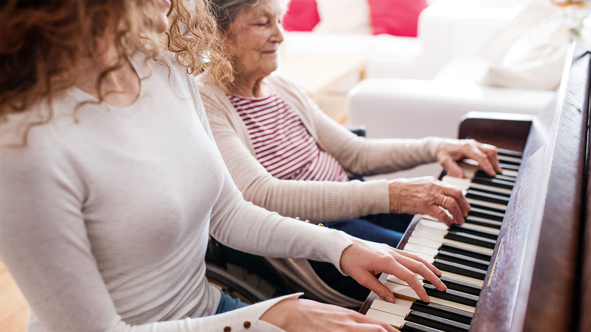 Women playing the piano together