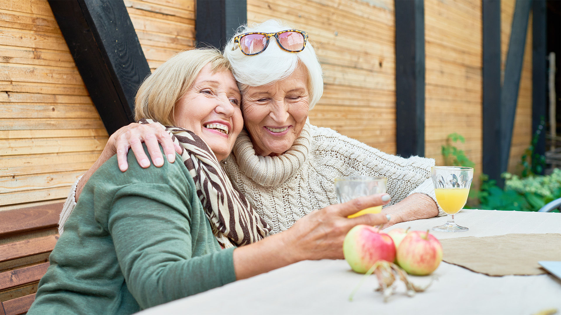 senior mother and daughter outdoors hugging