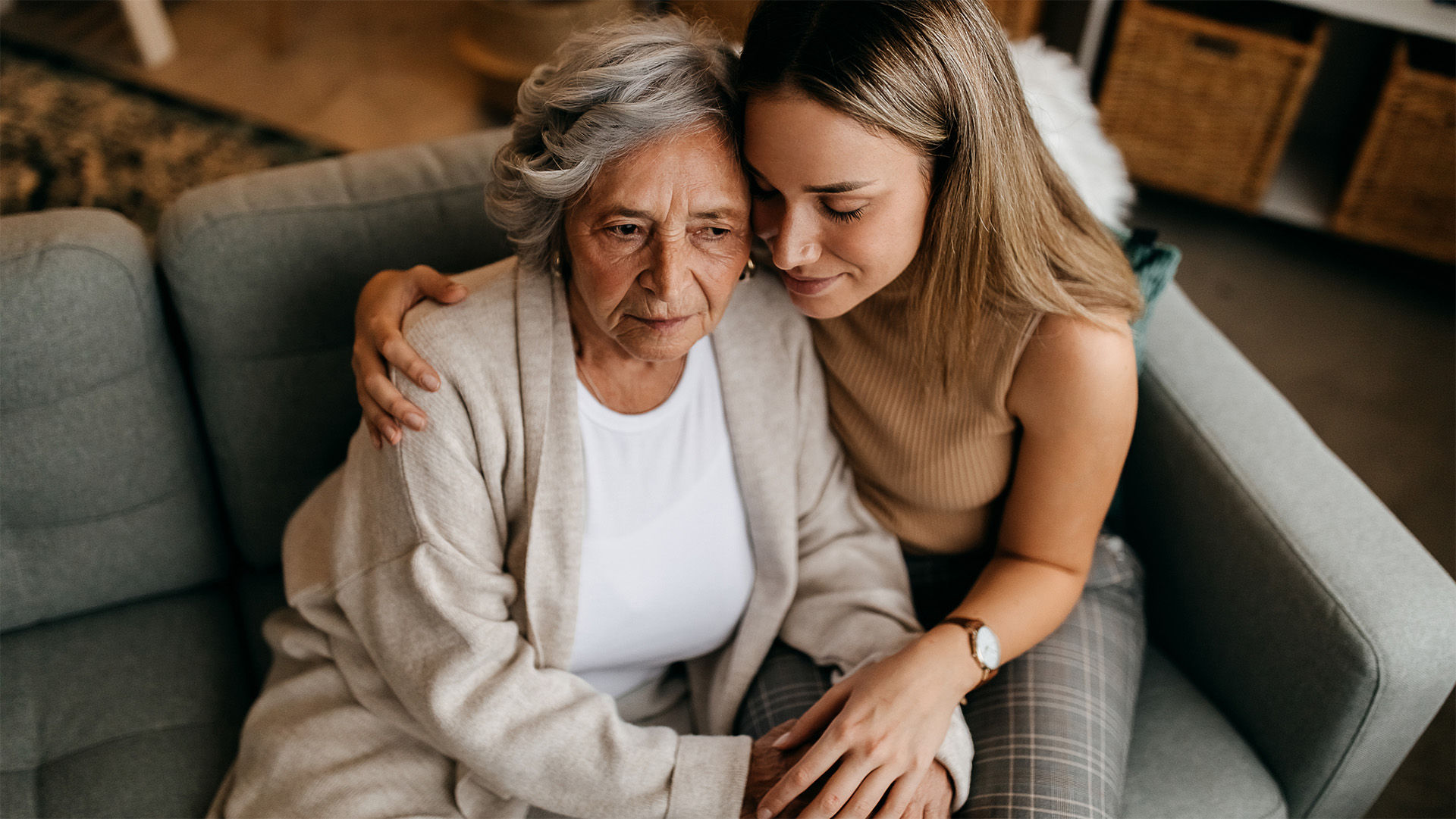 Mom and daughter hugging on a couch