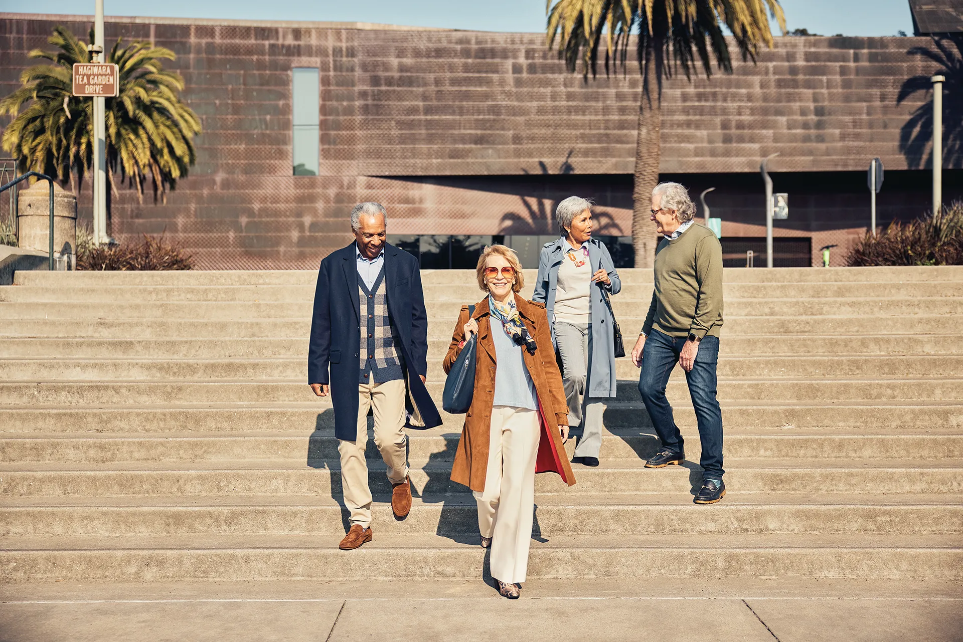 A group of seniors walk down a set of stairs