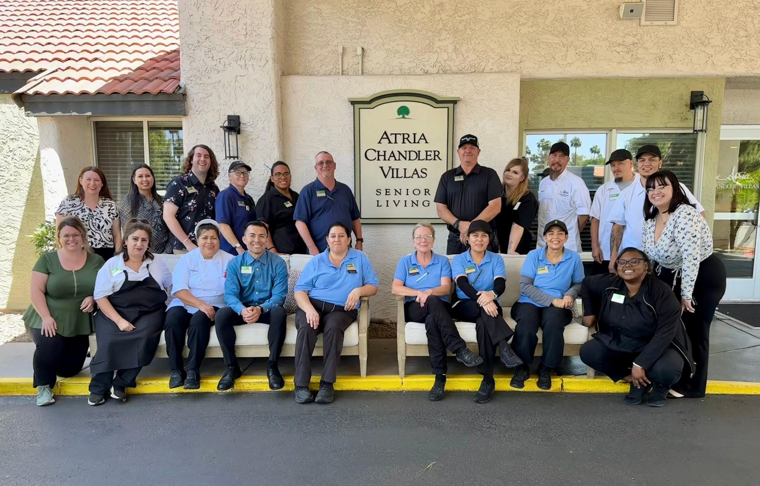 Atria Chandler Villas community leaders and employees posed in front of the community's entrance