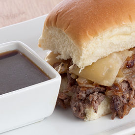 Two beef sliders with au jus sauce