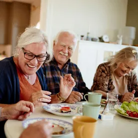 Senior residents sharing a meal and laughing