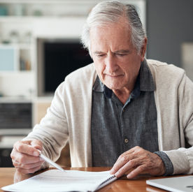 Senior man reviewing his budget sheet