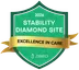 Green shield badge with "2026 Stability Diamond Site," "Excellence in Care" on a gold ribbon, and "ZIBRIO" logo at the bottom.