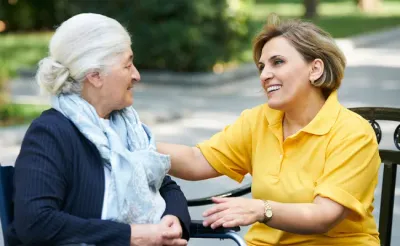 Senior resident chatting with caregiver.