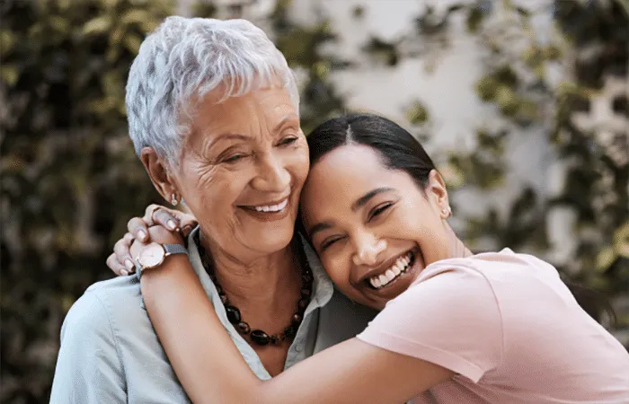 Coterie resident hugging family member and smiling