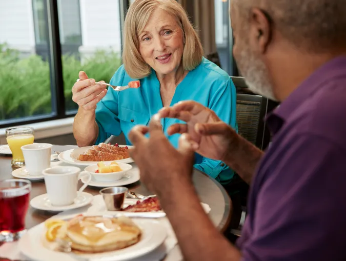Senior man and woman having breakfast
