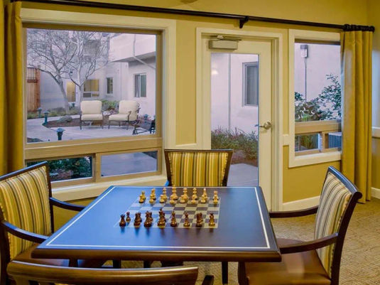 Atria Sunnyvale senior living community game room with courtyard view