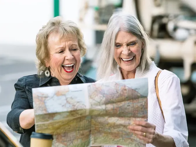 Two senior residents looking at an unfolded map