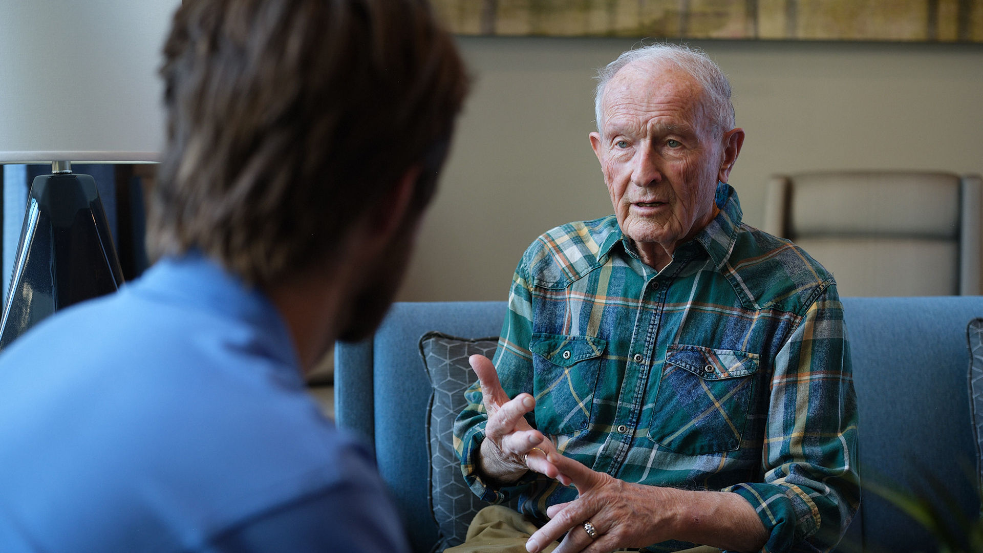 Older man talking with a Atria employee