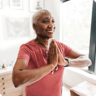 Senior woman doing yoga in her apartment