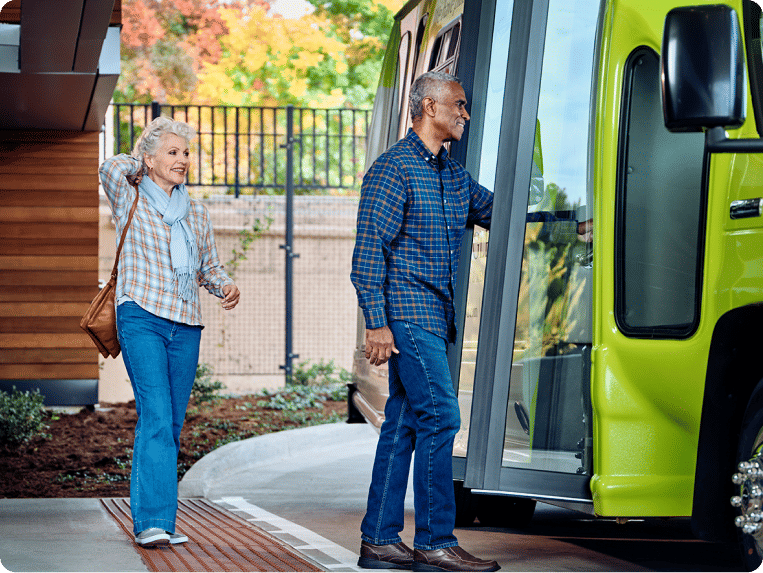 Two Atria residents getting on the bus