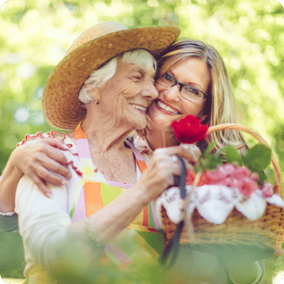 Senior woman and her adult daughter gardening on a nice summer day